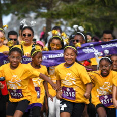 A group of Girls on the Run participants cross the Start line. 